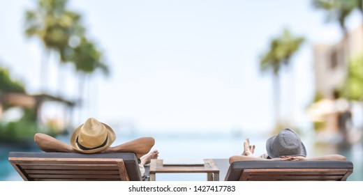 Summer Resort Hotel Stay Relaxation With Tourist Traveller Couple Take It Easy Happily Resting On Beach Chair On Holiday Travel Vacation Poolside Peacefully At Tropical Beach House Swimming Pool