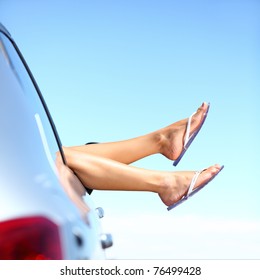 Summer Road Trip Car Vacation Concept. Woman Legs Out The Windows In Car Above The Clouds. Conceptual Freedom, Travel And Holidays Image With Copy Space.