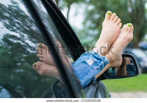Summer
road trip car vacation concept. Woman legs out the windows in car.
Conceptual freedom, travel and holidays
image.