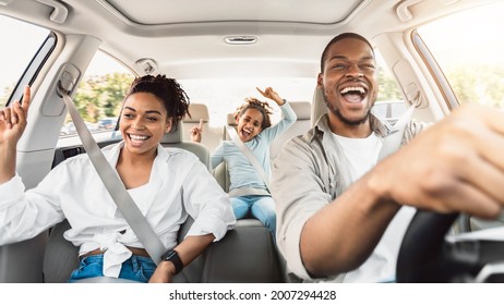 Summer Road Trip. Happy Black Family Of Three Riding Car And Singing Having Fun Traveling By Automobile. Parents And Daughter Enjoying Auto Ride Together On Weekend. Panorama, Selective Focus