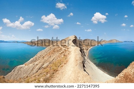 Summer rocky coastline and camping on sandy beach (Tihaja Bay (Koktebel Town in left), Crimea, Ukraine ). All peoples and cars is aunrecognizable.