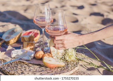 summer romantic lunch on the coastline of sea. composition with rose wine in glasses, camamber cheese, apricots, melon, hamon and baguette.  - Powered by Shutterstock