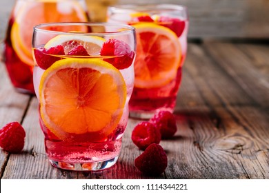 Summer Rose Cocktail. Sparkling Lemon Raspberry Lemonade Sangria In Glass On Wooden Background