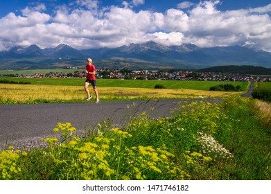 Summer Running Training. Long Distance Runner Train In Summer Landscape