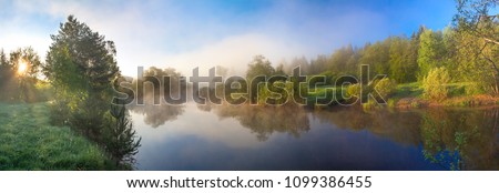 summer rural landscape panorama with river, fog and forest at sunrise