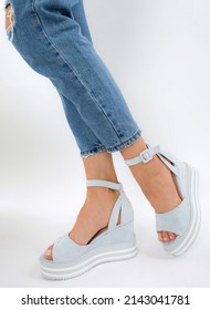 Summer Sandals On Women's Feet On A White Background