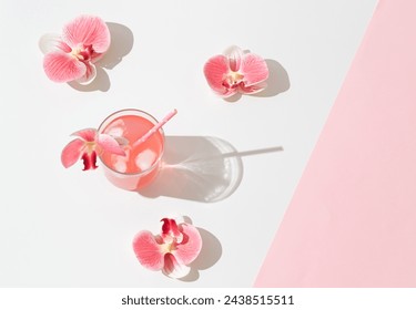 Summer scene made with pink tropical refreshing drink and orchid flowers on white and pink background. Sun and shadows. Minimal cocktail concept. Trendy summertime party idea. Summer aesthetic. - Powered by Shutterstock