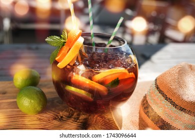 Summer Scenery In A Bar With Fruity Fresh Sangria. Vacation Background With Straw Hat And Golden Bokeh. Short Depth Of Field And Space For Text.