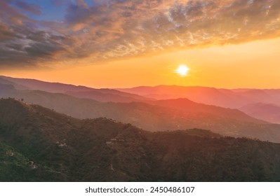 summer scenery mountain view from a highland hill to a beautiful sunset with green hills and slopes. Evening mountain landscape of amazing cloudy susnet above rocks - Powered by Shutterstock