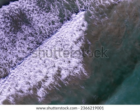 Similar – Luftaufnahme Panoramadrohne Blick auf den blauen Ozean Wellen, die am Sandstrand in Portugal erdrücken.