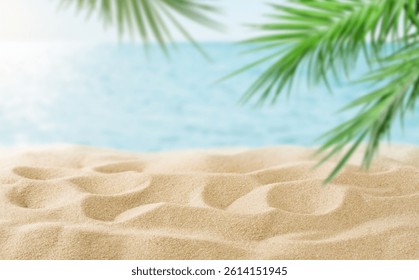 Summer sea and seascape with palm branches, clean beige sand and yacht in foreground with empty space for text. Defocus blurred travel and vacation backdrop. Abstract summer background design element