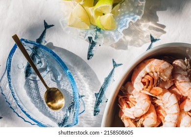 Summer Seafood Supper Table Spread To Make Fish Tacos, Prawns, Guacamole, Lime, Tortilla, Salsa On Blue And White Fish Tablecloth In The Sun