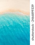 Summer seascape beautiful closeup. Blue sea water in sunny day. Top view from drone. Sea aerial surf, amazing tropical nature background. Mediterranean bright sea bay waves splashing beach sandy coast