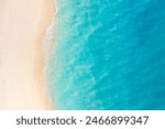 Summer seascape beautiful closeup. Blue sea water in sunny day. Top view from drone. Sea aerial surf, amazing tropical nature background. Mediterranean bright sea bay waves splashing beach sandy coast