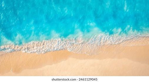 Summer seascape beautiful closeup. Blue sea water in sunny day. Top view from drone. Sea aerial surf, amazing tropical nature background. Mediterranean bright sea bay waves splashing beach sandy coast