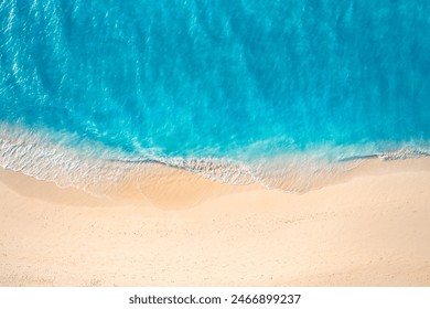 Summer seascape beautiful closeup. Blue sea water in sunny day. Top view from drone. Sea aerial surf, amazing tropical nature background. Mediterranean bright sea bay waves splashing beach sandy coast