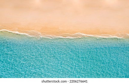 Summer seascape beautiful waves, blue sea water in sunny day. Top drone view. Sea aerial view, amazing tropical nature background. Beautiful bright sea waves surf on bright Mediterranean beach sand