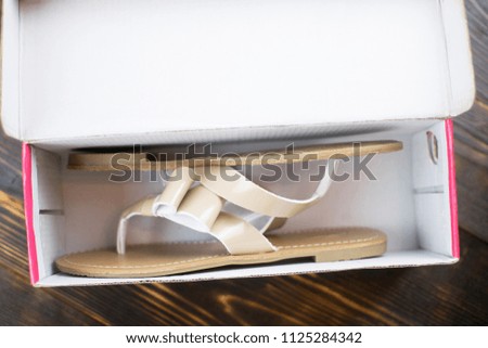 summer shoes in a shoe box