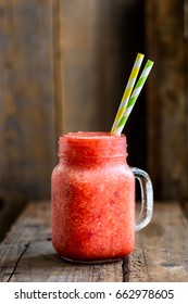 Summer Slushy from Strawberries, Lime and Ice on dark rustic background