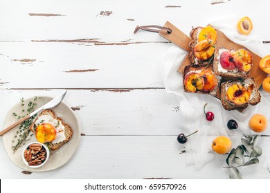 Summer Snack: Sandwiches With Grilled Peaches, Cream Cheese, Thyme And Pecan On Distressed White Wooden Background