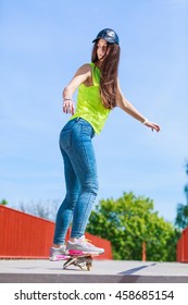 Summer sport and active lifestyle. Cool teenage girl in full length skater riding skateboard on the street. Outdoor. - Shutterstock ID 458685154