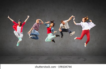 summer, sport, dancing and teenage lifestyle concept - group of teenagers jumping - Powered by Shutterstock