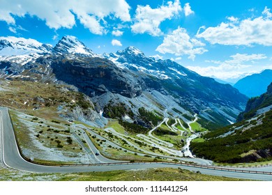 Summer Stelvio pass with alpine road and snow on slope (Italy)
