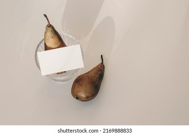 Summer Still Life Composition. Modern Business Card Mock Up Scene. Two Pears Fruit, Glass With  Long Harsh Shadows Overlay. Beige Table Background In Sunlight. Flat Lay, Top View, No People. 