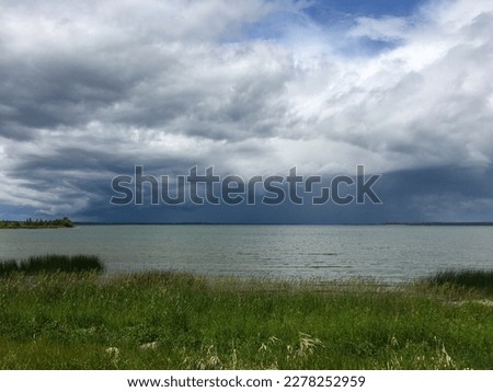 Summer storm brewing over Lac La Biche lake Alberta.