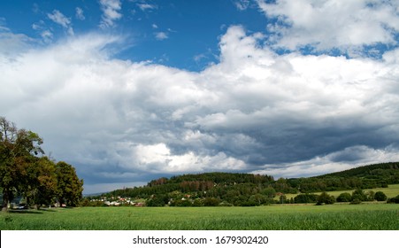 Summer storm clouds. Bits of blue sky. Rain coming. Weather