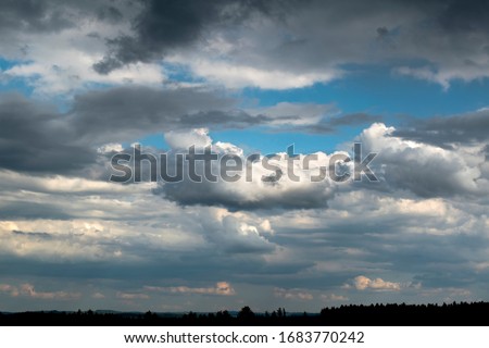 Summer storm clouds. Bits of blue sky. Rain coming. Weather
