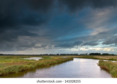 Summer Storm coming in with Brooding Cloudy Sky above a Broad River in the  Evening