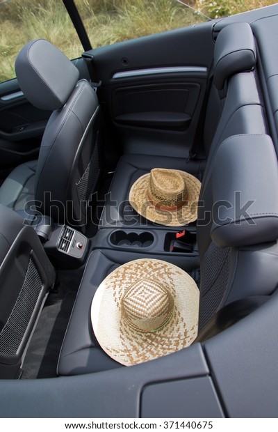 Summer, Sun,\
Car with two straw hats  in\
cabriolet