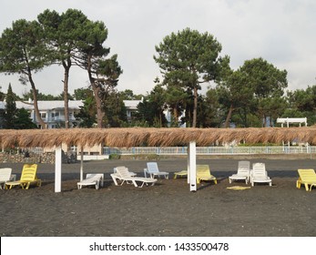 Summer, Sun, Deserted Beach Of The Coast With Sun Loungers. Beach By The Sea With Empty Deck Chairs Set In A Row. Deserted Place To Stay. Abandoned Resort. Georgia, Ureki - June 2019