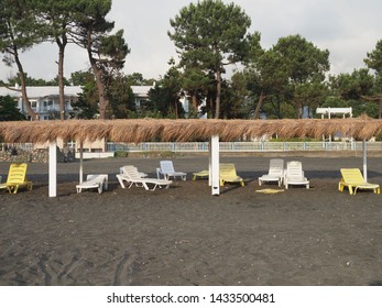 Summer, Sun, Deserted Beach Of The Coast With Sun Loungers. Beach By The Sea With Empty Deck Chairs Set In A Row. Deserted Place To Stay. Abandoned Resort. Georgia, Ureki - June 2019