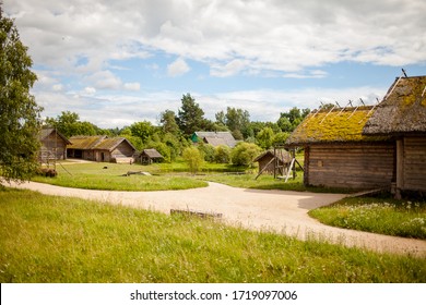 Summer sunny day in a russian village. The landscape depicts old wooden houses, trees and shrubs. Image with selective focus. - Shutterstock ID 1719097006