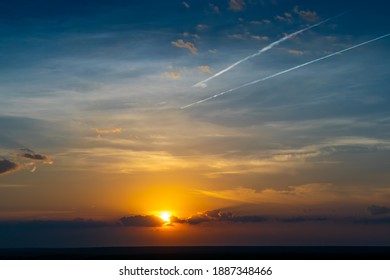 Summer Sunrise With Clouds And Vapour Trail In The Sky