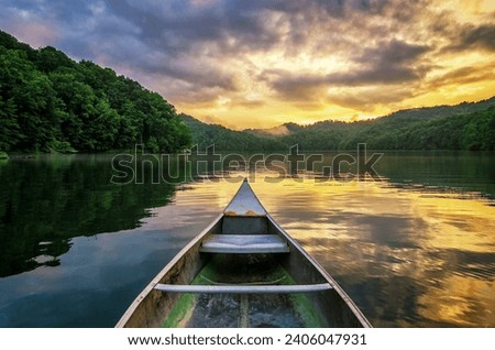 Summer sunset, mountain lake, aluminum canoe