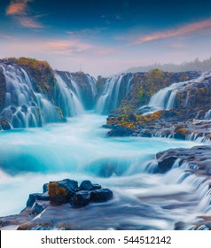 Summer sunset with unique waterfall - Bruarfoss. Colorful evening scene in South Iceland, Europe. Artistic style post processed photo.