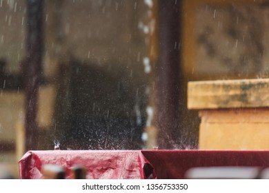 Summer Terrace Of The Restaurant In The Rain. Wet The Table With A Burgundy Tablecloth. A Spray Of Water. Rainy Weather.