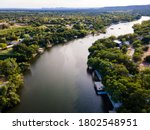Summer time above Lake LBJ in the Texas Hill Country near Burnet , Texas aerial drone views above curved Colorado River and green summer landscape