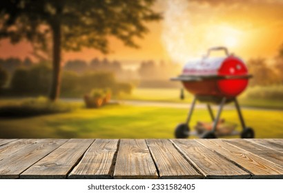 summer time in backyard garden with grill BBQ, wooden table, blurred background - Powered by Shutterstock