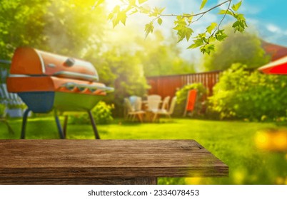 summer time in backyard garden with grill BBQ, wooden table, blurred background - Powered by Shutterstock