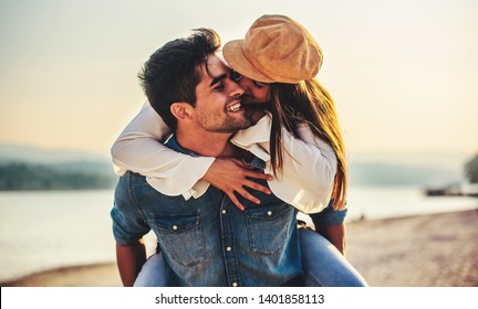 Summer time. Beautiful young couple enjoying in a good mood on the beach. Lifestyle, love, dating, vacation concept - Powered by Shutterstock