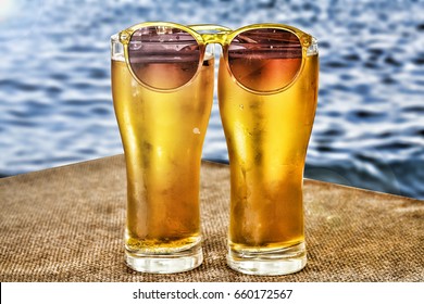 Summer time. Beer in glasses against the background of the ocean or the sea. Concept: rest by the sea, vacation, travel. - Powered by Shutterstock