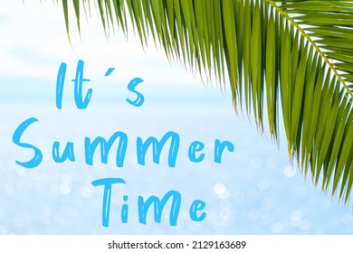 Its summer time message written in elegant font on the background with palm leaf and blue sea. Holiday concept and advertising of tour agency. 