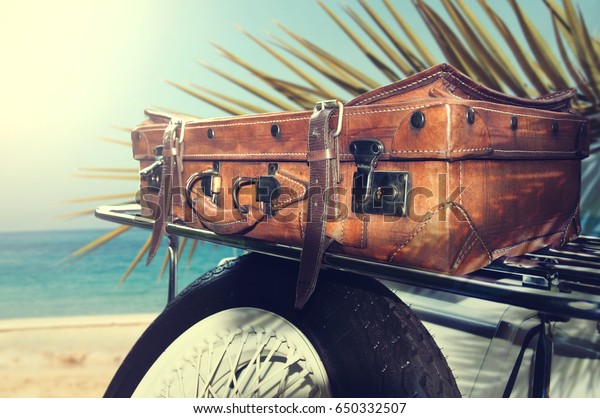 summer time and\
old car with vintage\
suitcase.