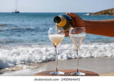 Summer time in Provence, two glasses of cold champagne cremant sparkling wine on sandy beach near Saint-Tropez in sunny day, Var department, vacation in France - Powered by Shutterstock