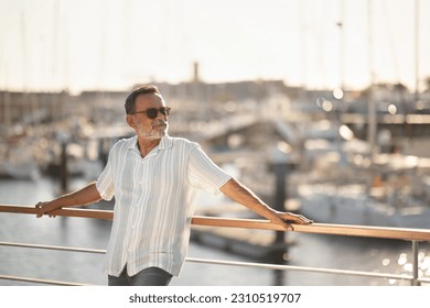 Summer Time. Senior Man Posing Among Yachts Enjoying Holidays Adventures And Sea Breeze Standing Outside At Marina Pier. Gentleman Looking Aside At Free Space Planning His Retirement Travel - Shutterstock ID 2310519707