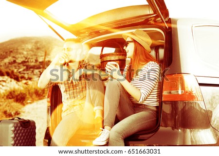 Similar – Two young women resting sitting inside of car